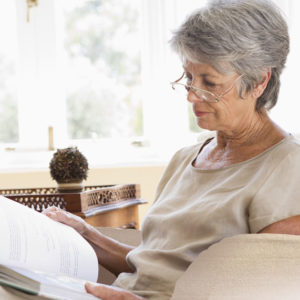 elderly woman reading in a chair